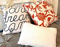 All three pillows arranged on bed showing patterns and shapes