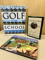 All three golf books displayed upright and flat