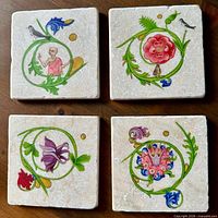 All four marble tiles shown together displaying distinct illuminated designs