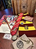 Overall lot showing scarf, tie, wand, map, ticket, letter, watch, key, wallet, keychain