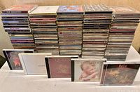 Front view of entire lot showing two tall stacks of jewel cases and several highlighted cases in front