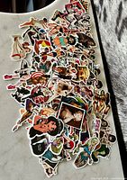 Pile of assorted retro pin-up, tattoo and pop culture stickers spread on surface