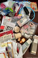 Overview of entire mixed crafting lot showing papers, kits, tools, wood pieces, punches and accessories