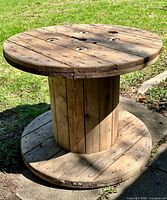 Full view of wooden cable spool table outdoors
