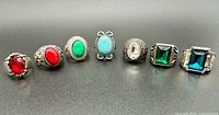 Front view of all seven rings in a row highlighting stone colors and settings