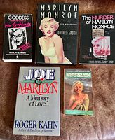 Five Marilyn Monroe themed books laid out front covers visible