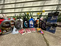 Group shot of all automotive fluids, car care products, bulbs and accessories lined up outdoors