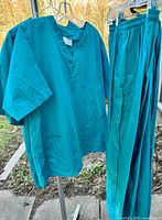 Scrub top and pants hanging on rack, shows overall style and colour