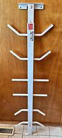 Front view of one security bar showing quick-release latch and mounting plate