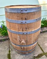 Full view of wooden barrel showing metal bands and spigot