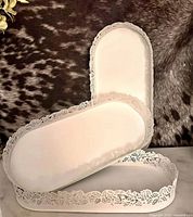 Three white oval metal trays showing overall size and design
