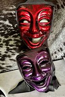Front view showing both masks stacked, red over purple
