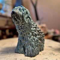 Front angled view showing textured teal glaze and overall form