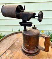 Full view of brass blowtorch showing burner, shroud, and handle