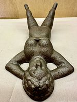 Top view of cast iron reclining nude female doorstop