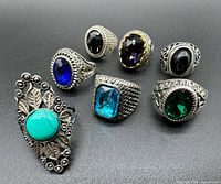 Group shot of all seven rings showing stones and band designs