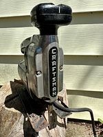 Front view showing Craftsman nameplate, cast metal body, black knob handle, cord exiting rear