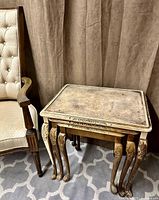 Nested set beside upholstered chair showing size and style
