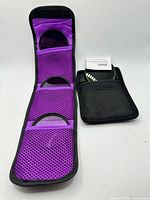 Tri-fold Altura wallet open showing three filters in purple mesh slots alongside Vivitar pouch