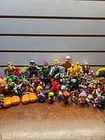 Full group of assorted figures and accessories on wooden surface