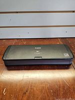 Scanner closed, top view showing Canon logo and compact form