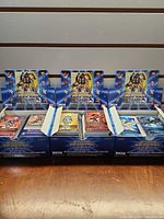 Three open display boxes filled with Digimon cards