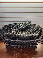 Stacked curved G scale track pieces, bundled