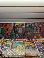 All eight bagged comics laid out in two rows