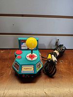 Front view of Namco plug and play joystick showing joystick, button, RCA cable