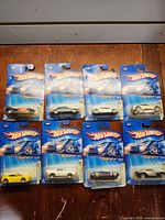 Group shot of 8 sealed Realistix cars on cards