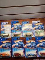 Eight sealed Hot Wheels X-Raycers cards laid out on table