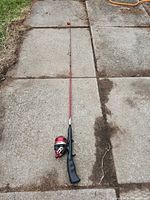 Full view of rod and reel laid on pavement