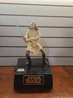 Front view of Qui-Gon Jinn figure on base