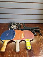 Full lot showing three paddles, net and clamp posts