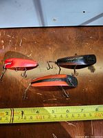 All three Helin Flatfish lures side by side next to ruler for scale