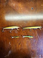 Top view of all four Rapala lures on wood surface