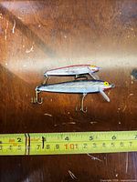 Two Rebel minnow lures side by side next to ruler for scale