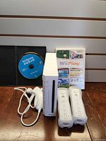 Console front view with accessories and games