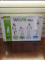 Front of retail box showing Wii Fit Plus branding and contents