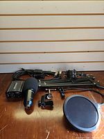 Entire microphone kit laid out including mic, boom arm, pop filter, phantom power supply, cables