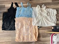 All four slips laid out: black, light blue, white, peach