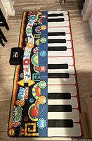 Full view of the Alex Gigantic Step & Play Piano mat with control box visible