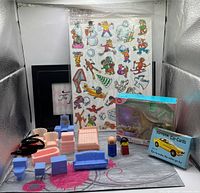 Group shot showing storyboard sheet, horse toy pack, Toyota card deck, figures and dollhouse furniture