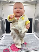 Full view of doll standing in white/yellow terry sleeper