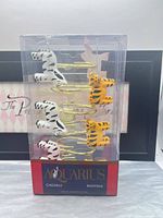 Front view of boxed hooks showing white zebra and orange tiger figures on gold hooks