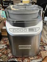 Front view of Cuisinart stainless steel ice cream maker showing lid, internal bowl, and digital control panel