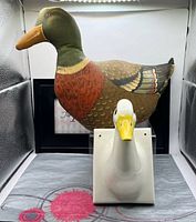 Front view showing both the ceramic duck towel hanger and the fabric duck door stop