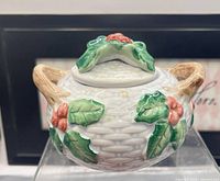 Front view of Fitz & Floyd Holly & Berry lidded bowl showing holly motif and handles