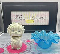 Front view of ceramic dog shaker and blue glass bowl