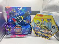 Front view of sealed Chase Deluxe Vehicle toy and sealed 48-piece hexagonal puzzle box